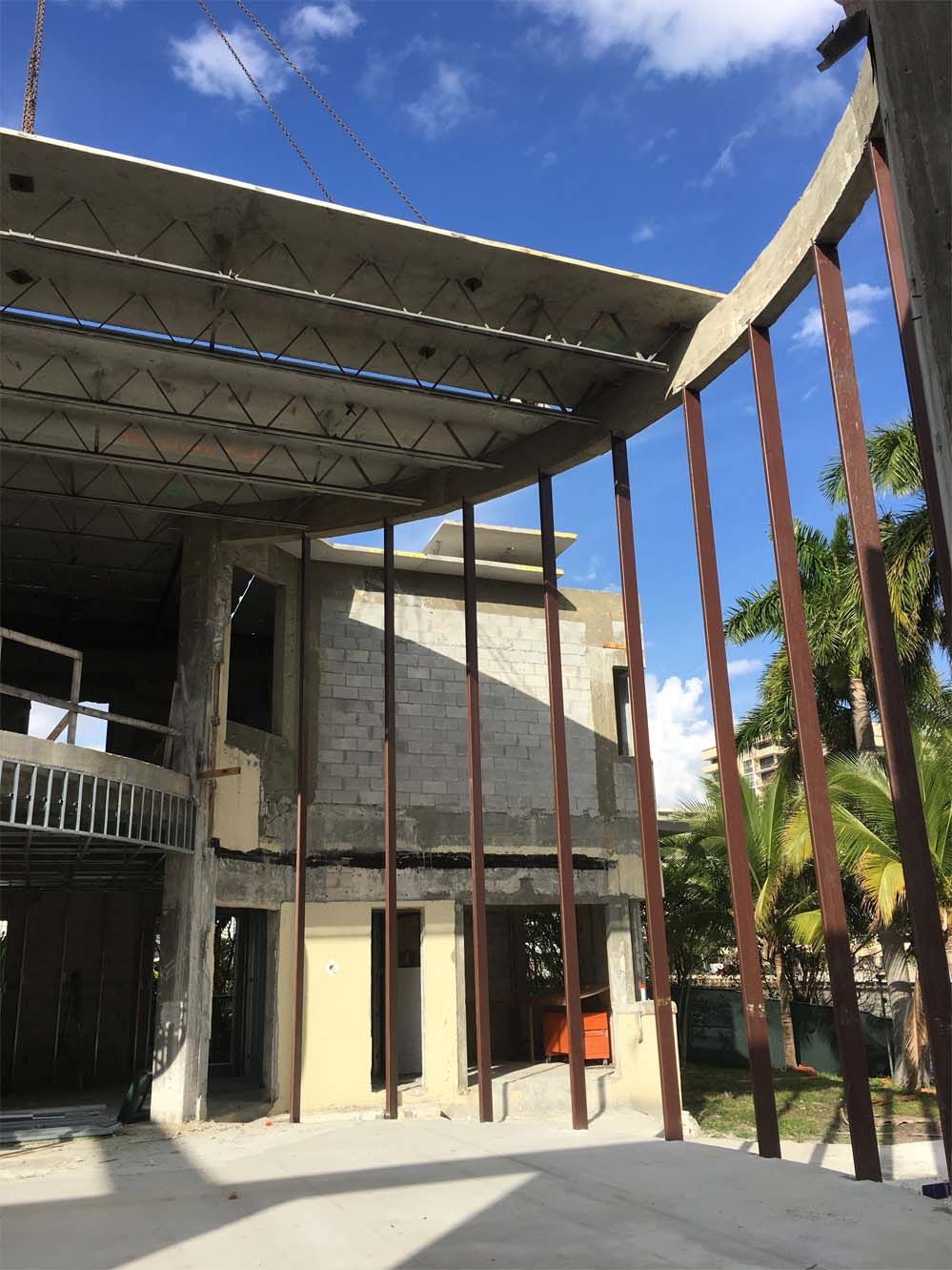 A building under construction with a blue sky in the background