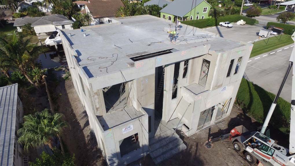 An aerial view of a building under construction in a residential area.