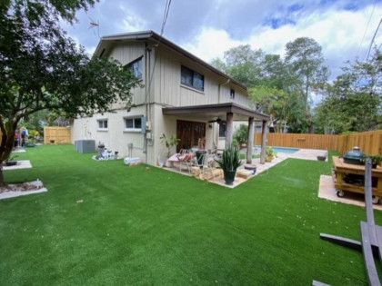 A large house with a large lawn in front of it.