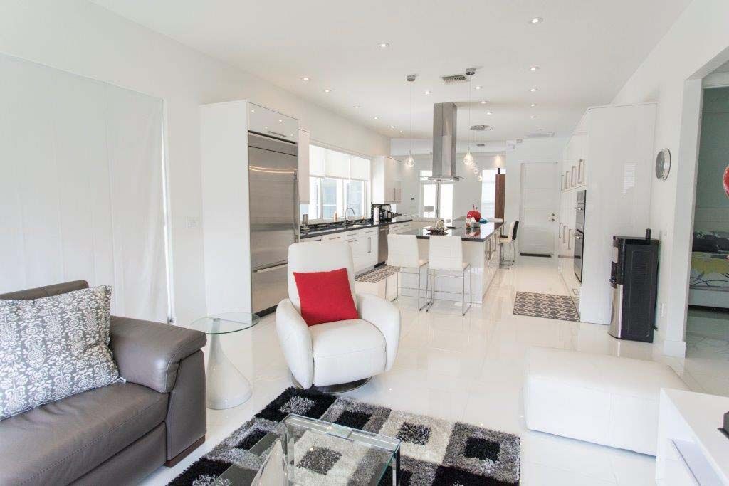 A living room with a couch , chair , table and rug.