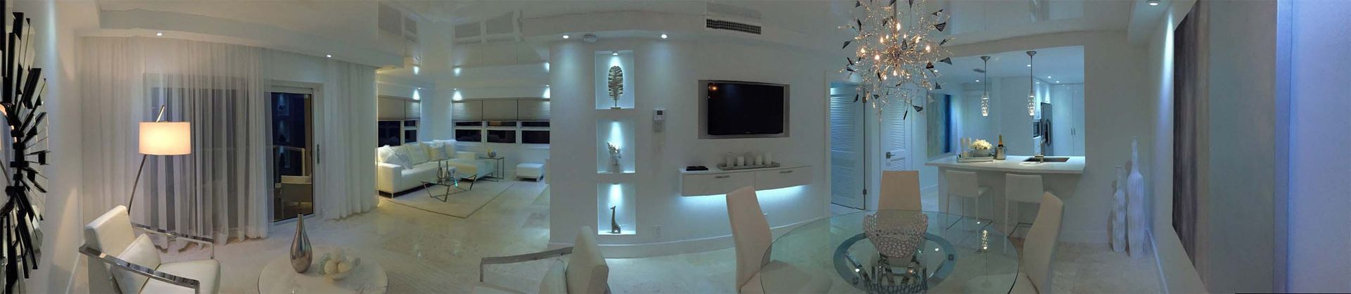 It is a very large room with a lot of furniture and a chandelier.