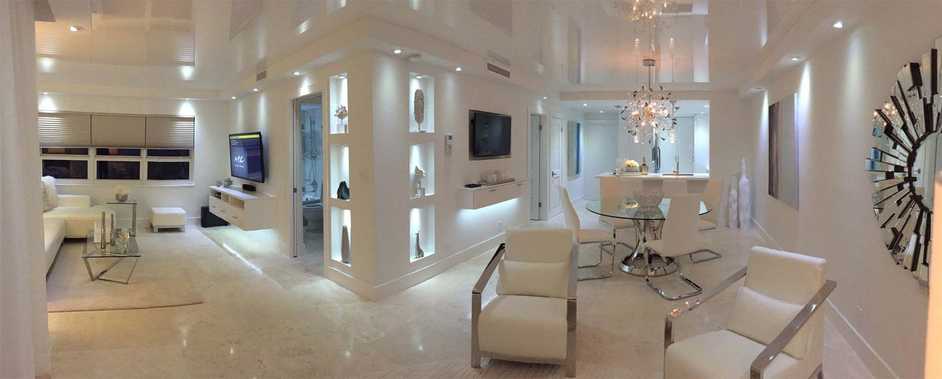 A living room with white furniture and a white ceiling.