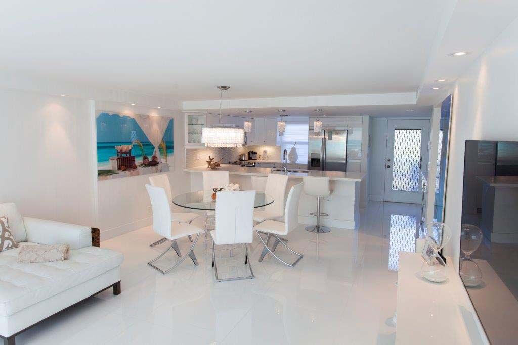 A living room with a dining table and chairs and a couch.