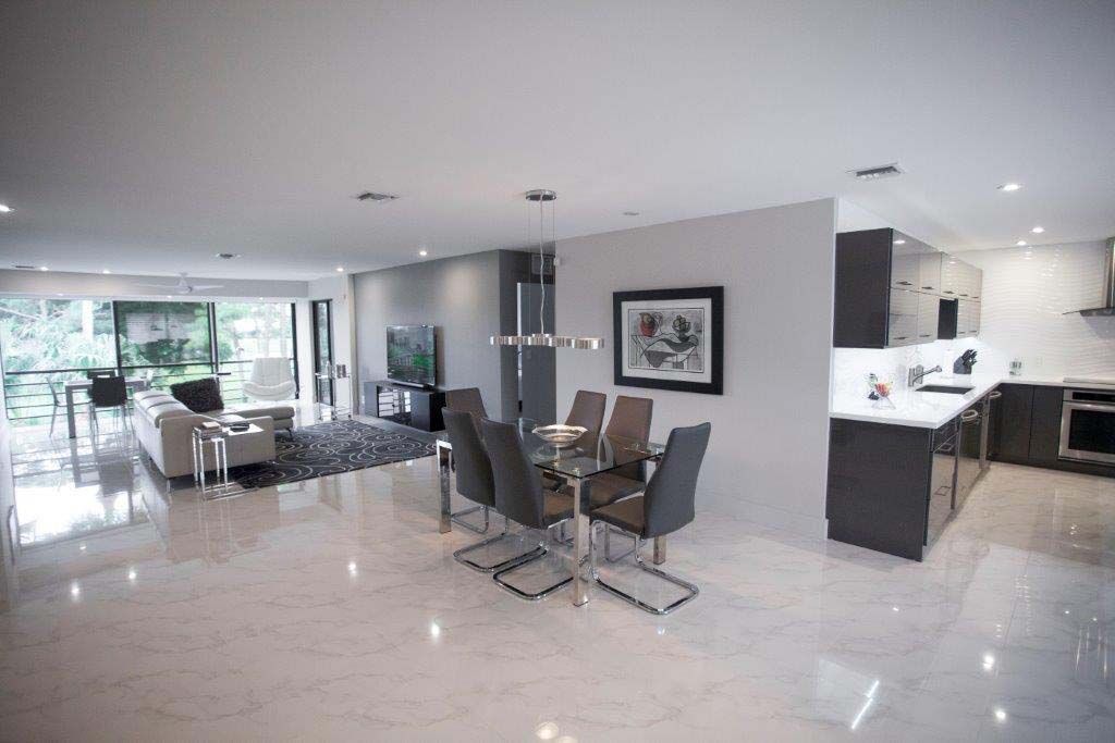 There is a dining table and chairs in the middle of the room.