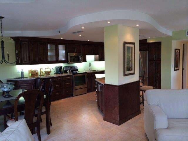 A living room with a kitchen and dining area
