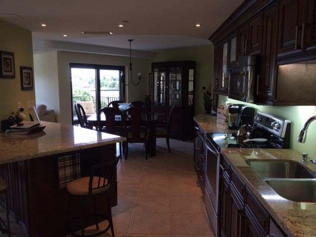 A kitchen with stainless steel appliances and granite counter tops