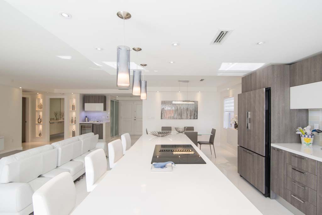A kitchen with a large island and a stove top oven.