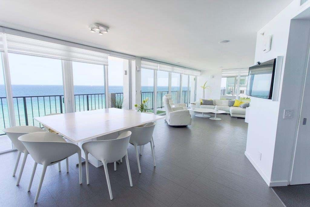 A large living room with a dining table and chairs
