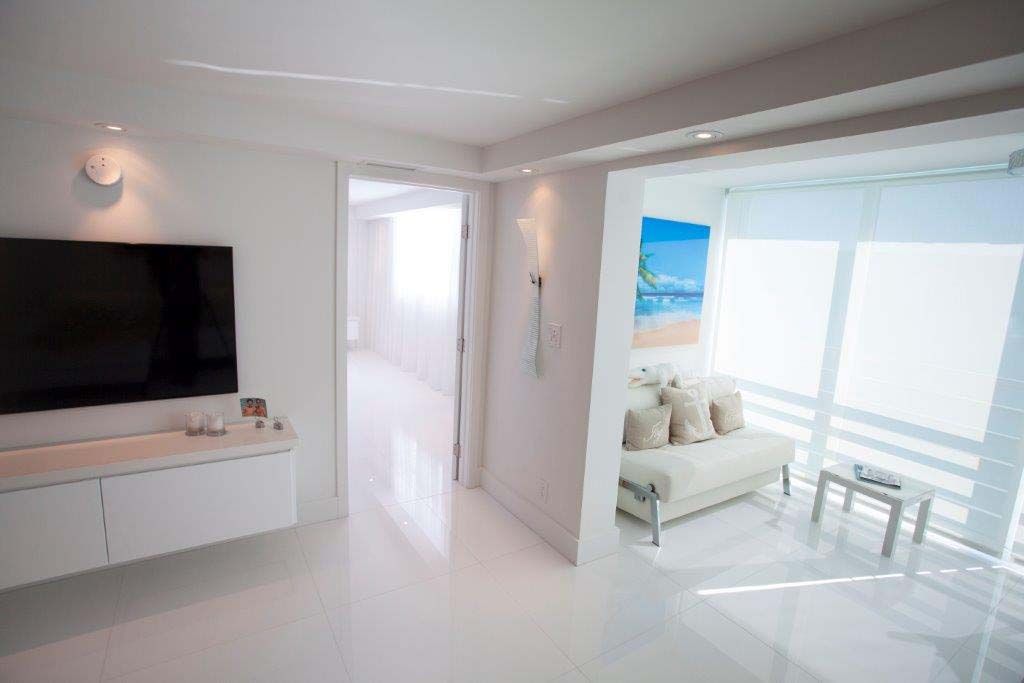 A living room with a couch and a flat screen tv.