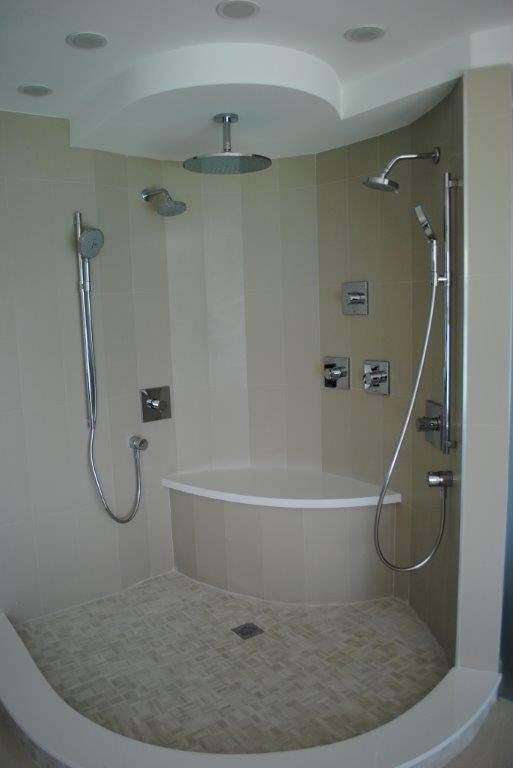A bathroom with a bathtub and a shower.