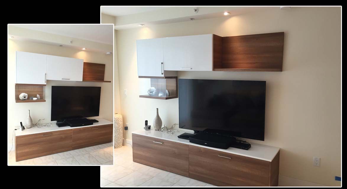 A living room with a flat screen tv and a wooden entertainment center