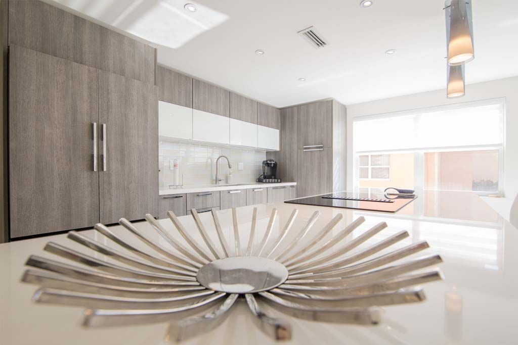 A silver bowl is sitting on a counter in a kitchen.