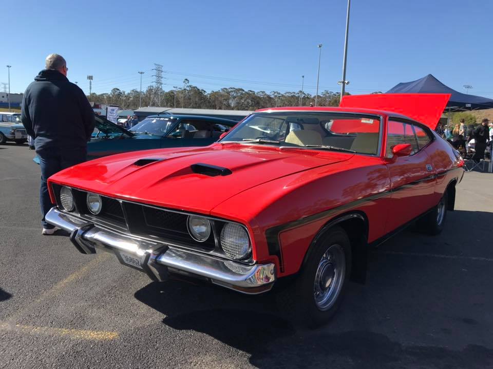 a bright red-coloured Ford classic muscle car