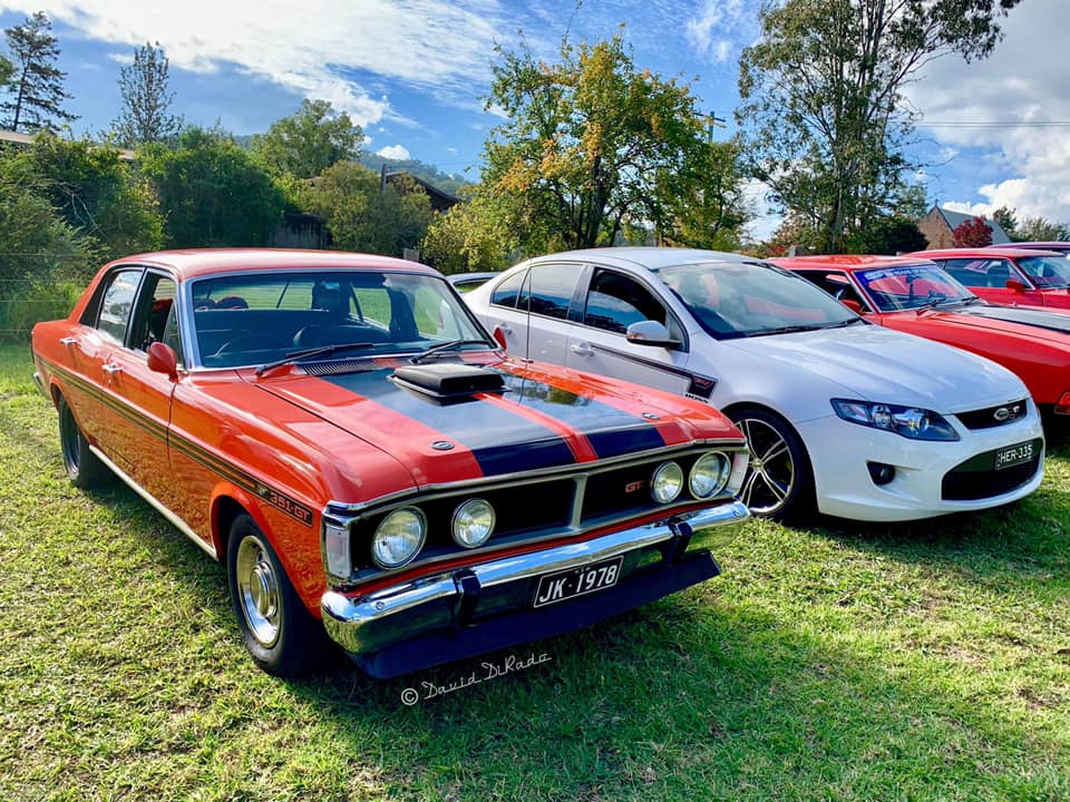 red classic Ford muscle car with black stripe
