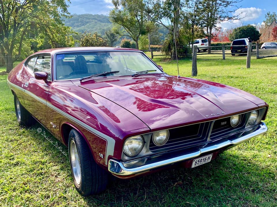 a maroon classic Ford muscle car