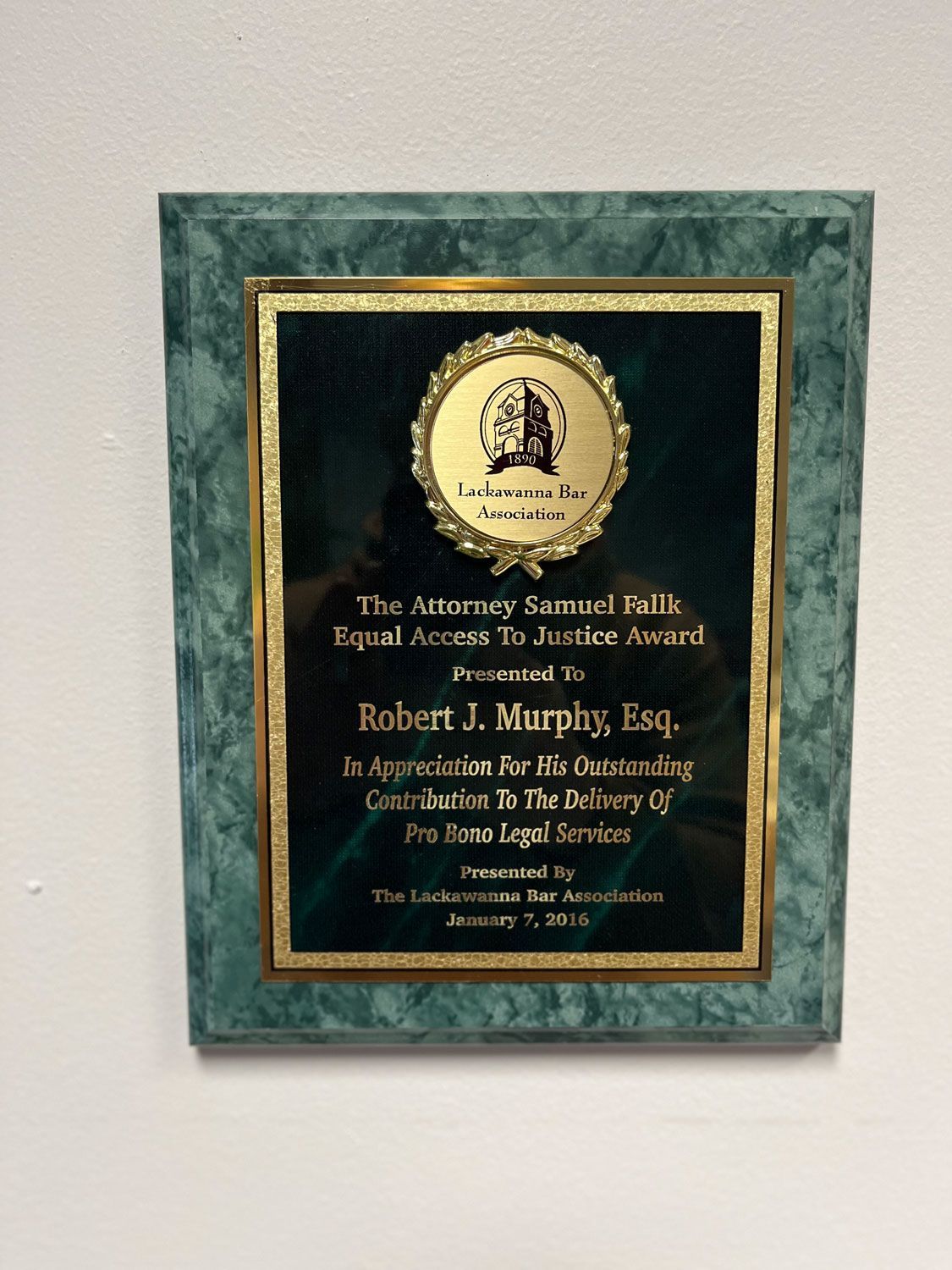 Plaque with green marble border, gold trim, and black text. Awarded to Robert J. Murphy, Esq. for pro bono legal service.