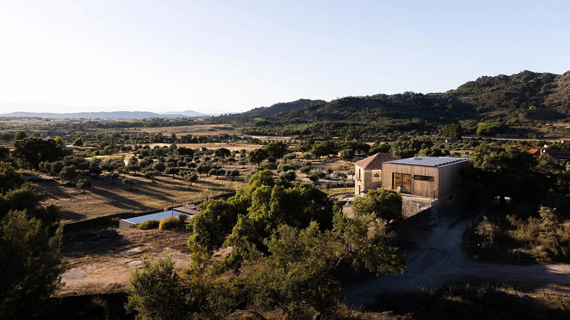 An aerial view of a house in the middle of a valley