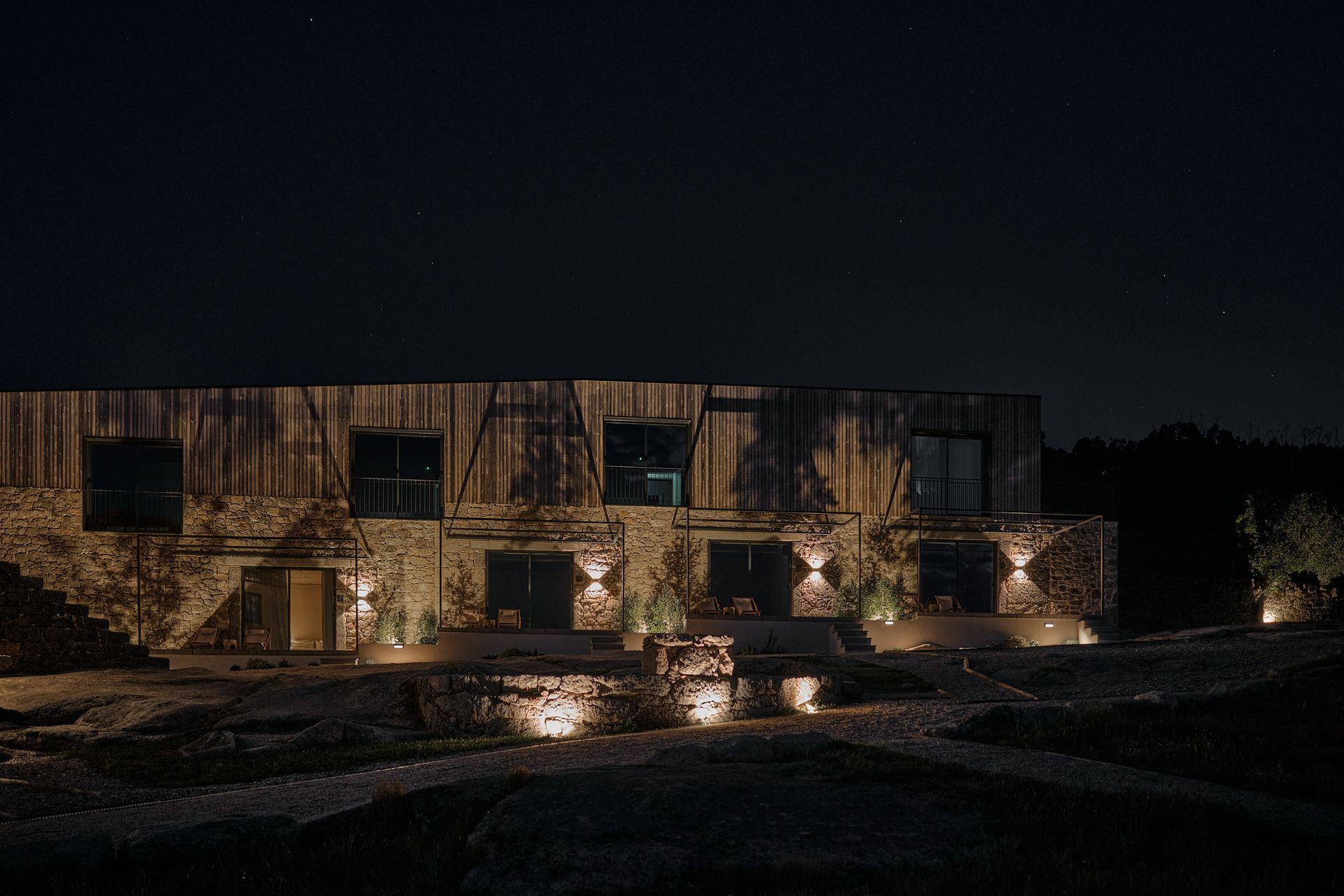 A large stone building is lit up at night.