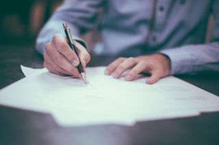 man at desk writing