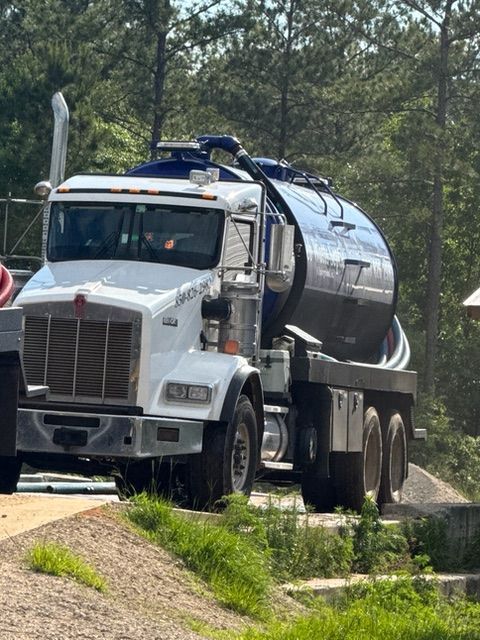 A tanker truck is parked on the side of the road.