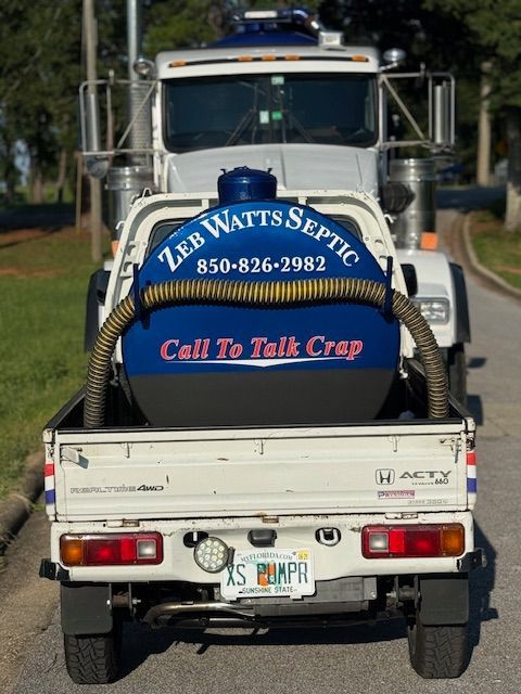 White truck with blue tank for Zeb Watts Septic service,