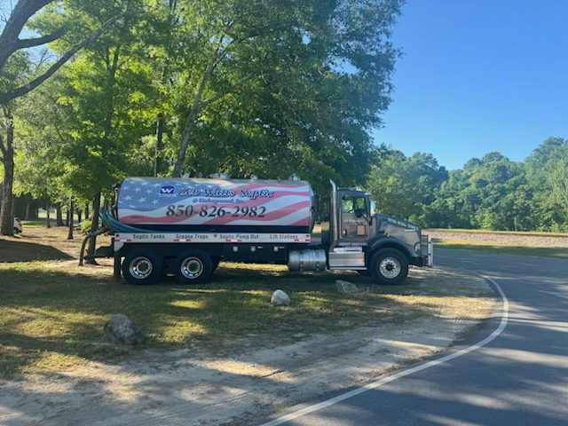 A tanker truck is parked on the side of the road.