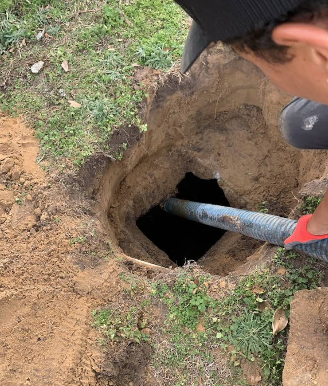 A tanker truck is parked on the side of the road.