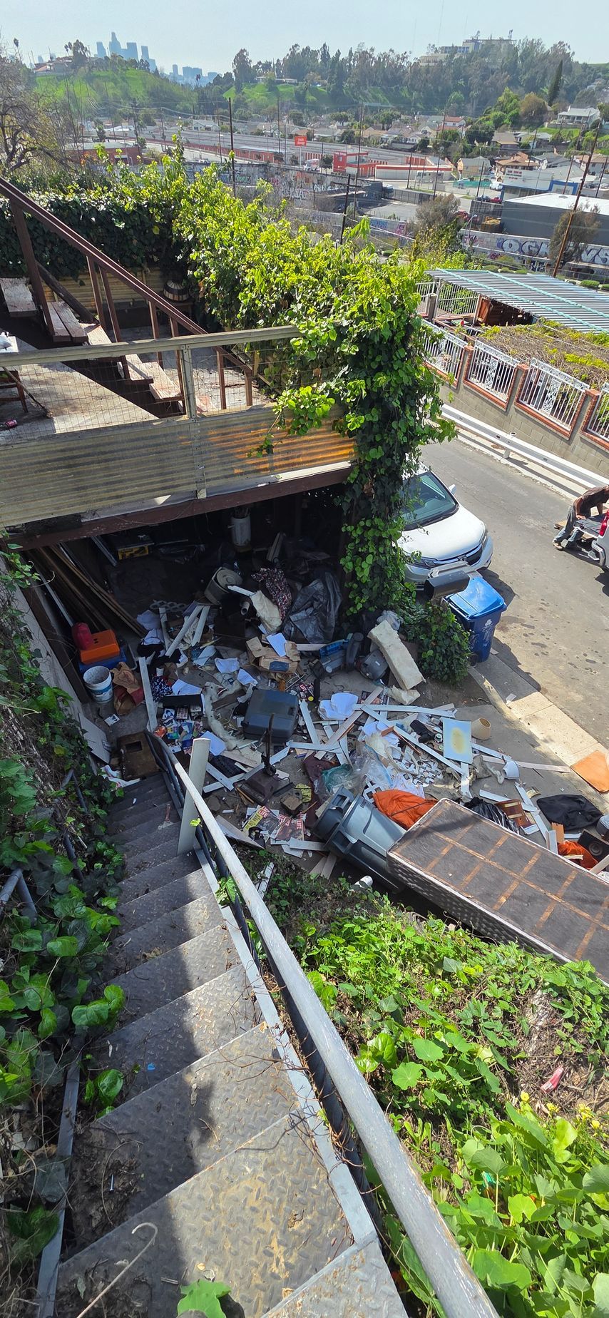 A staircase leading up to a building with a lot of trash on the ground.