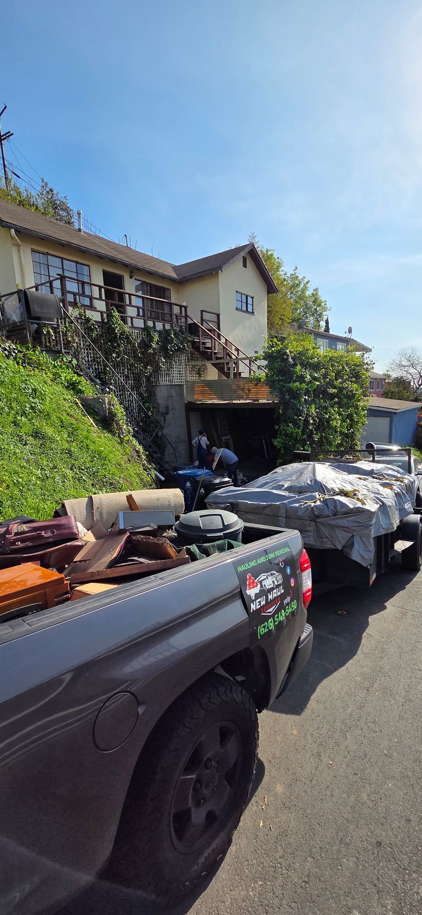 A truck is parked on the side of the road in front of a house.