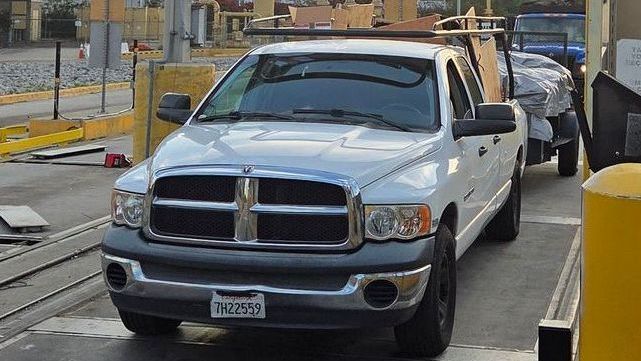 A white truck with a license plate that says tmz200