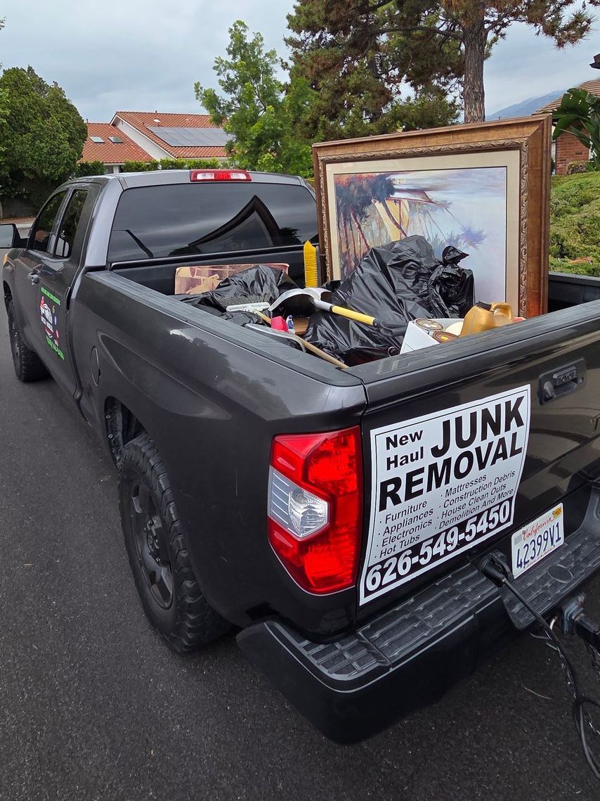 A junk removal truck with a picture in the back