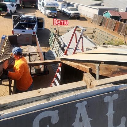 A man is working on a sign that says cal