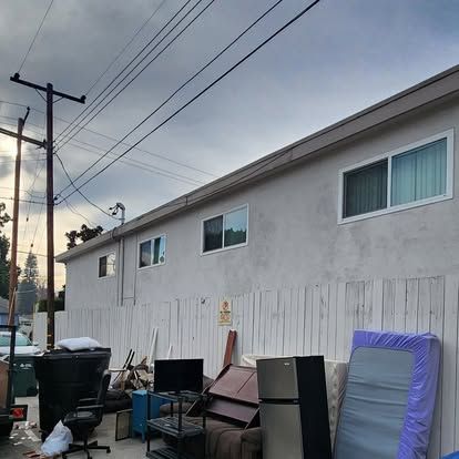 A white building with a lot of furniture in front of it.