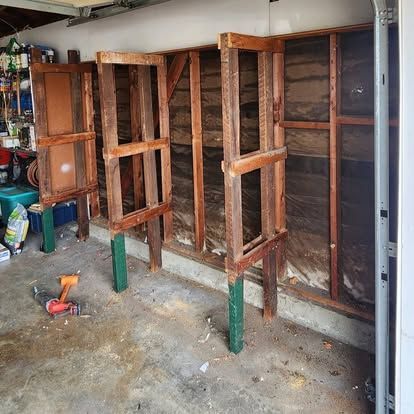 A garage with a lot of wooden frames on the walls.