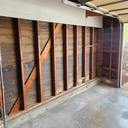 A garage with a wooden wall and a concrete floor.