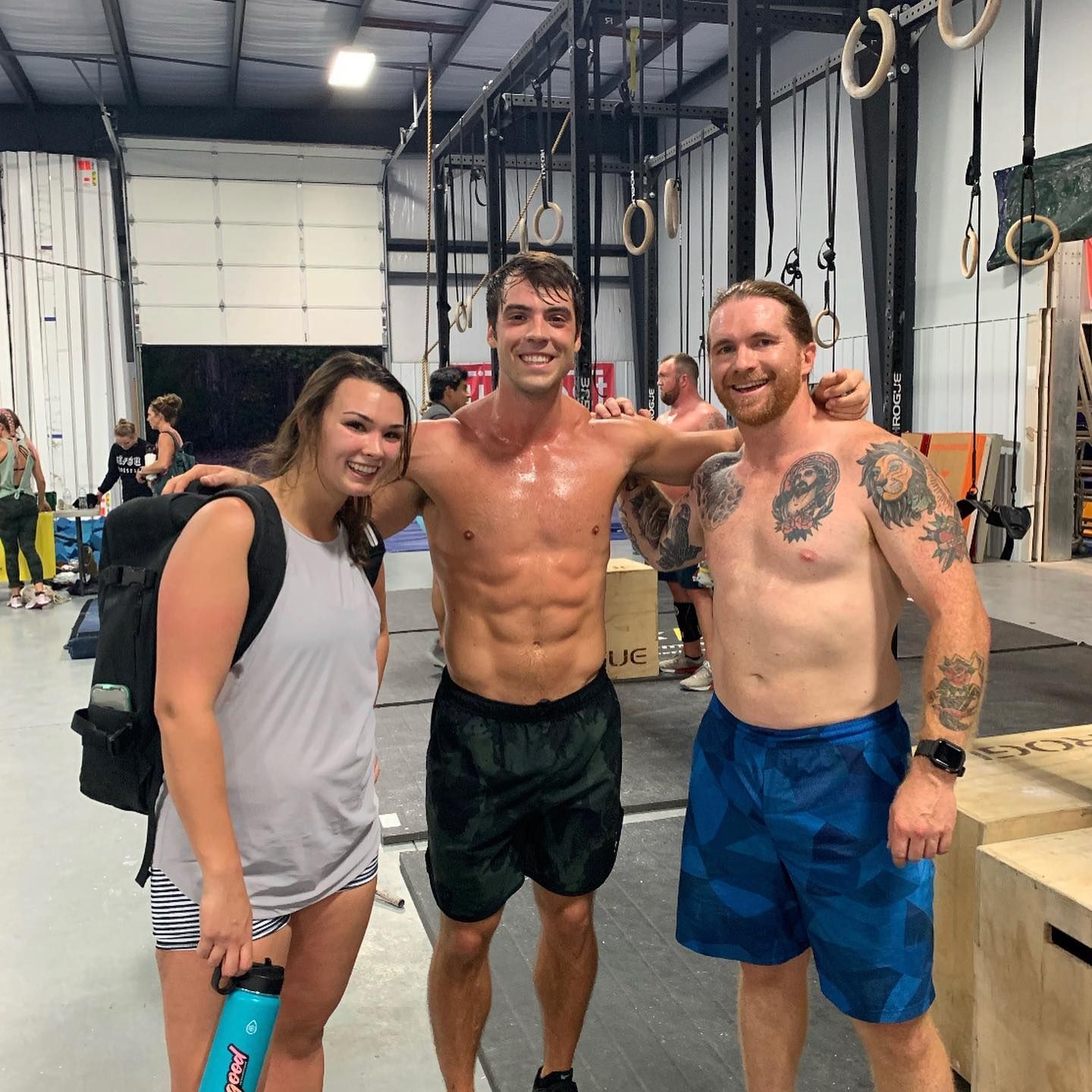 A group of people posing for a picture in a gym
