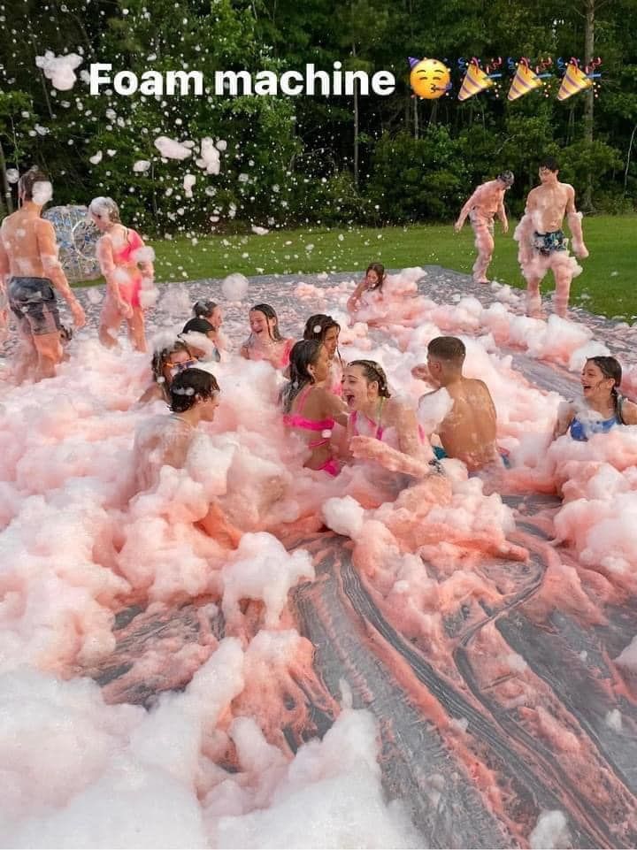 A group of people are playing in a foam machine.