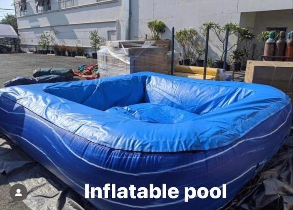A blue inflatable pool is sitting in a parking lot