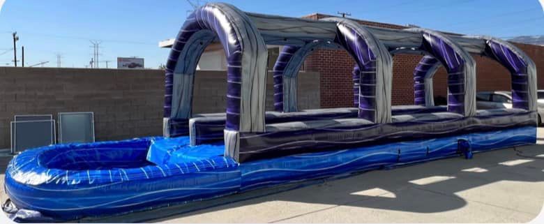 A large inflatable water slide is sitting on the side of the road.