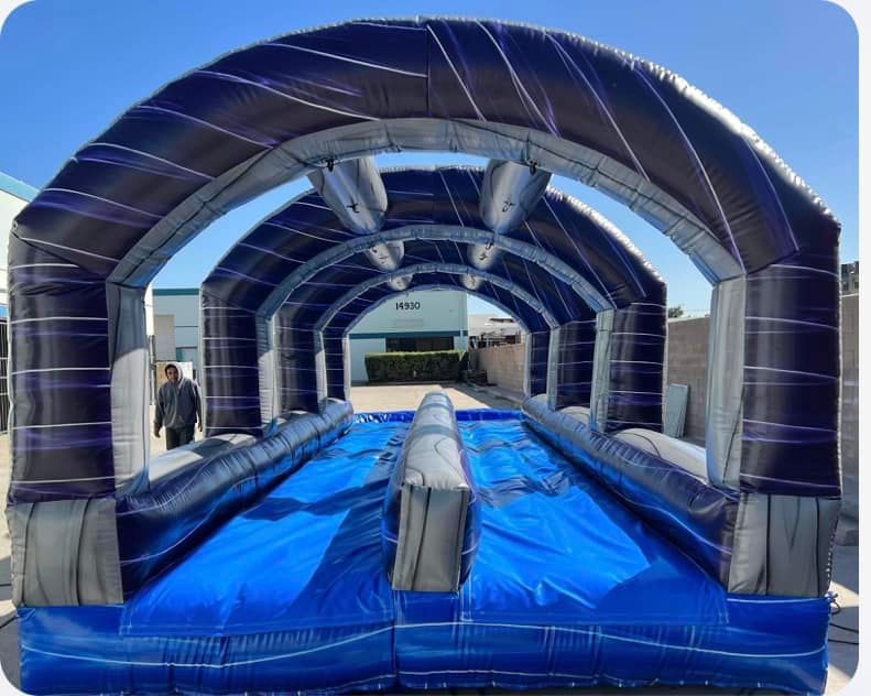 A large inflatable water slide is sitting in front of a building.