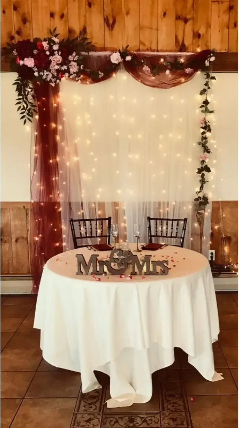 A table with a white tablecloth and a sign that says mr. and mrs. on it.