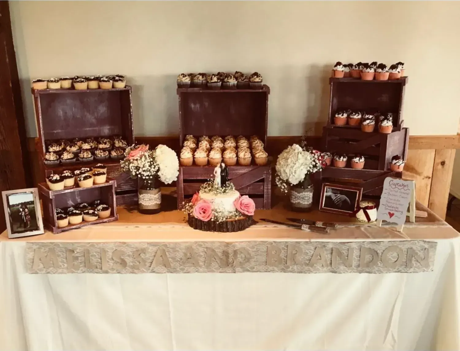 A table with a cake and cupcakes on it