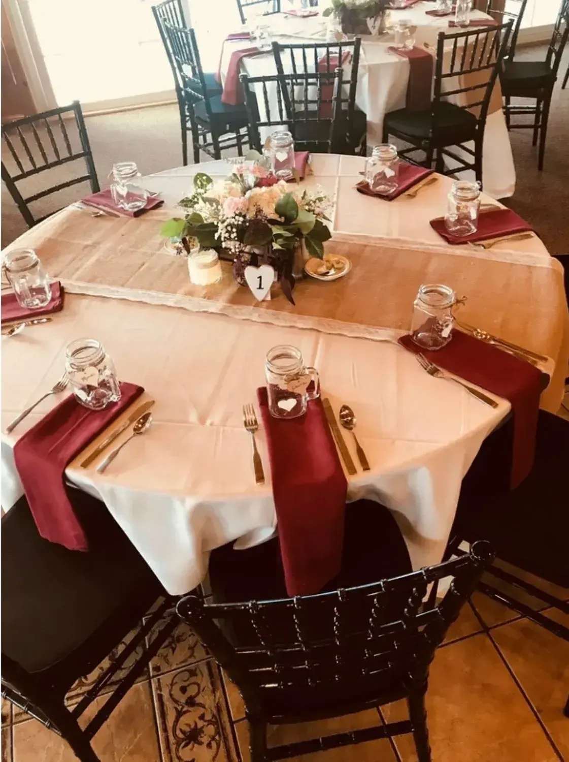 A restaurant with tables and chairs set up for a wedding reception.
