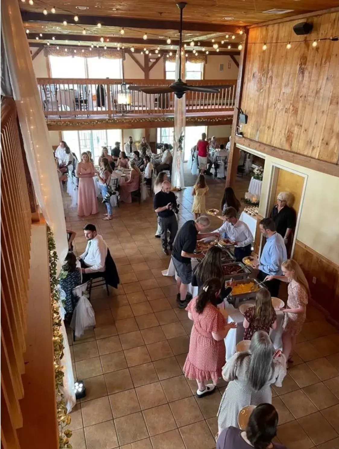 A group of people are standing around a table in a large room.