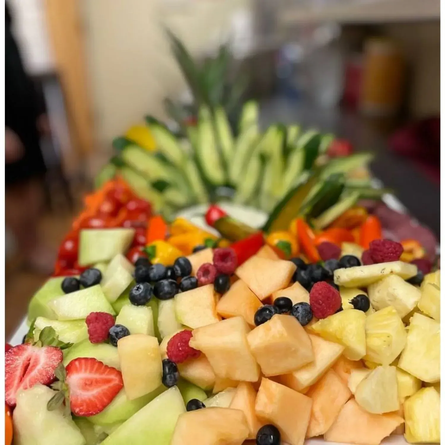 A tray of fruit and vegetables on a table.