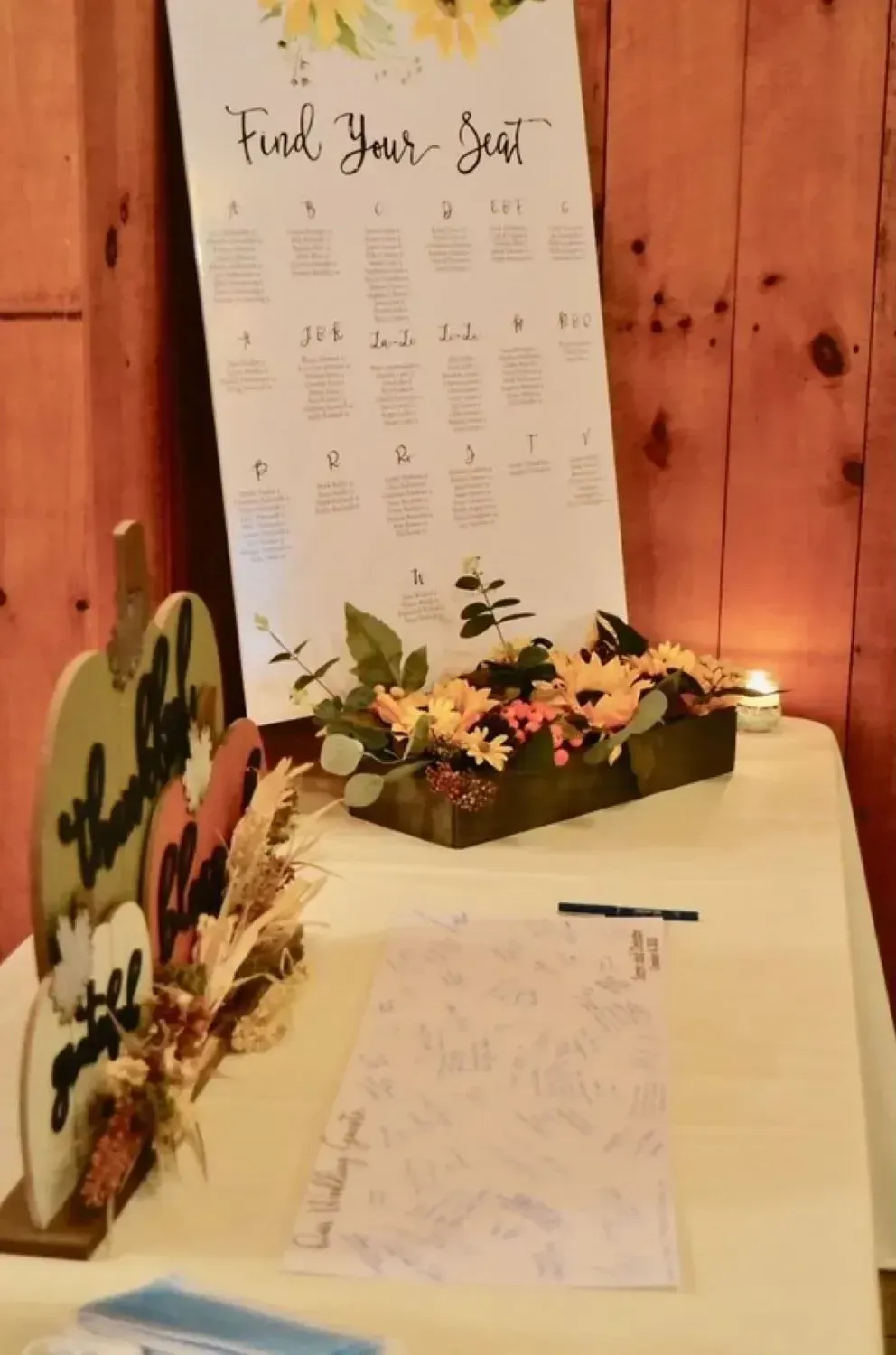 A table with a sign that says find your seat on it