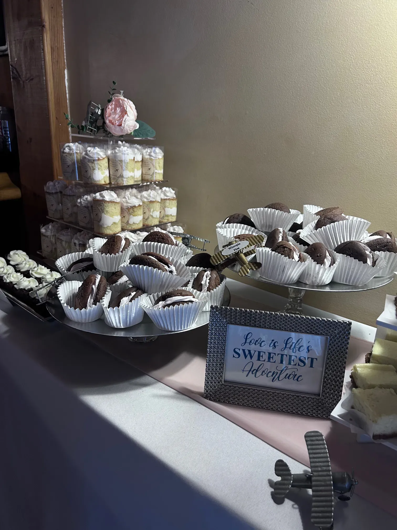 A table topped with a variety of desserts including chocolate covered strawberries and cupcakes.