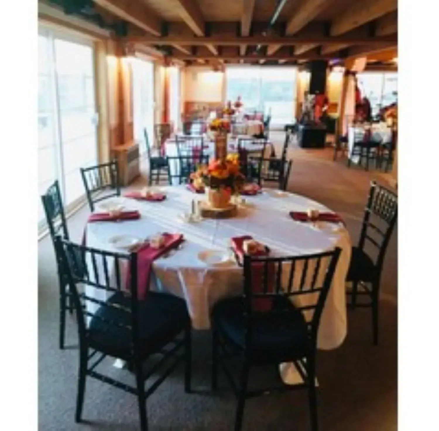 A large room with tables and chairs set up for a party