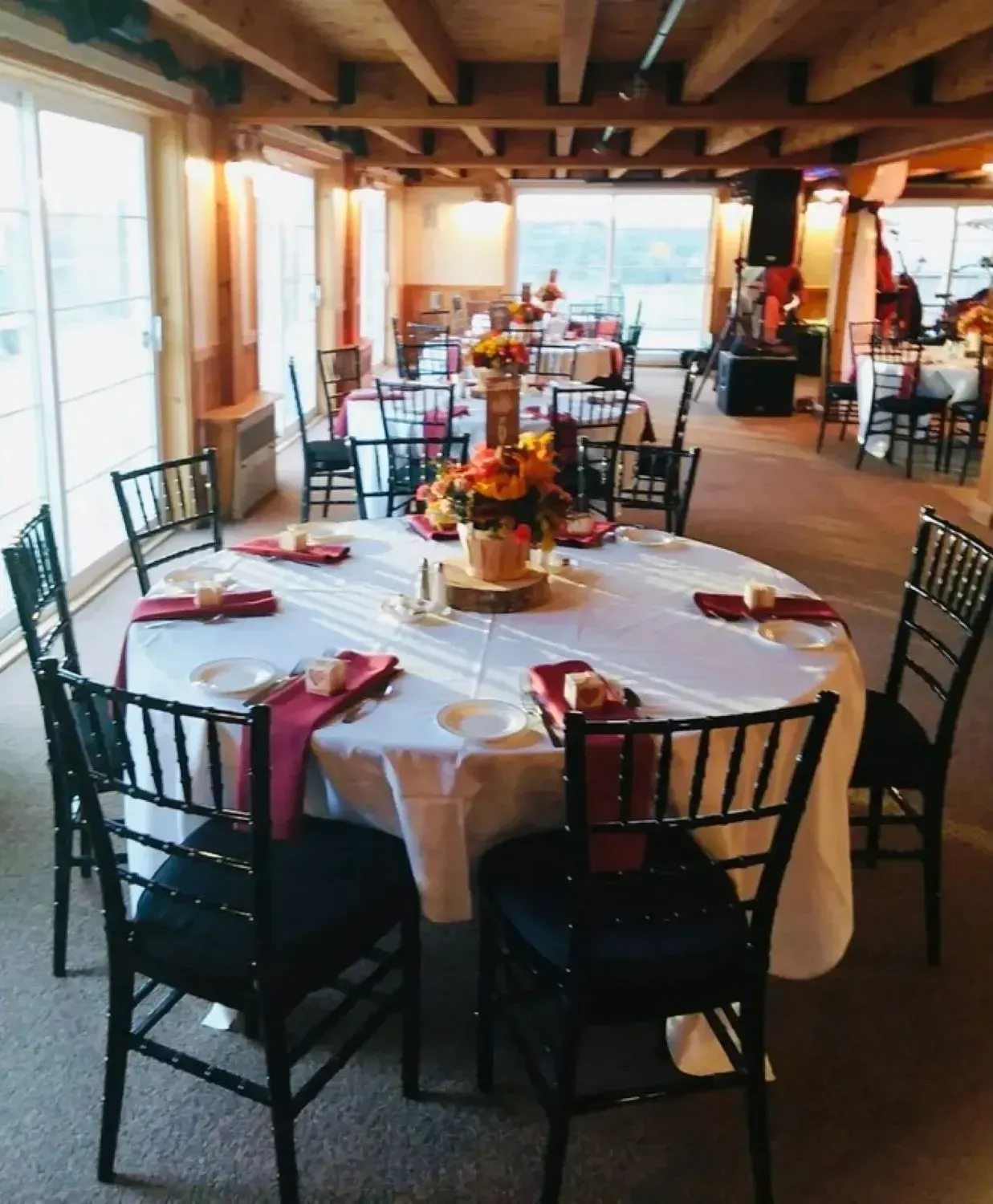 A large room with tables and chairs set up for a party