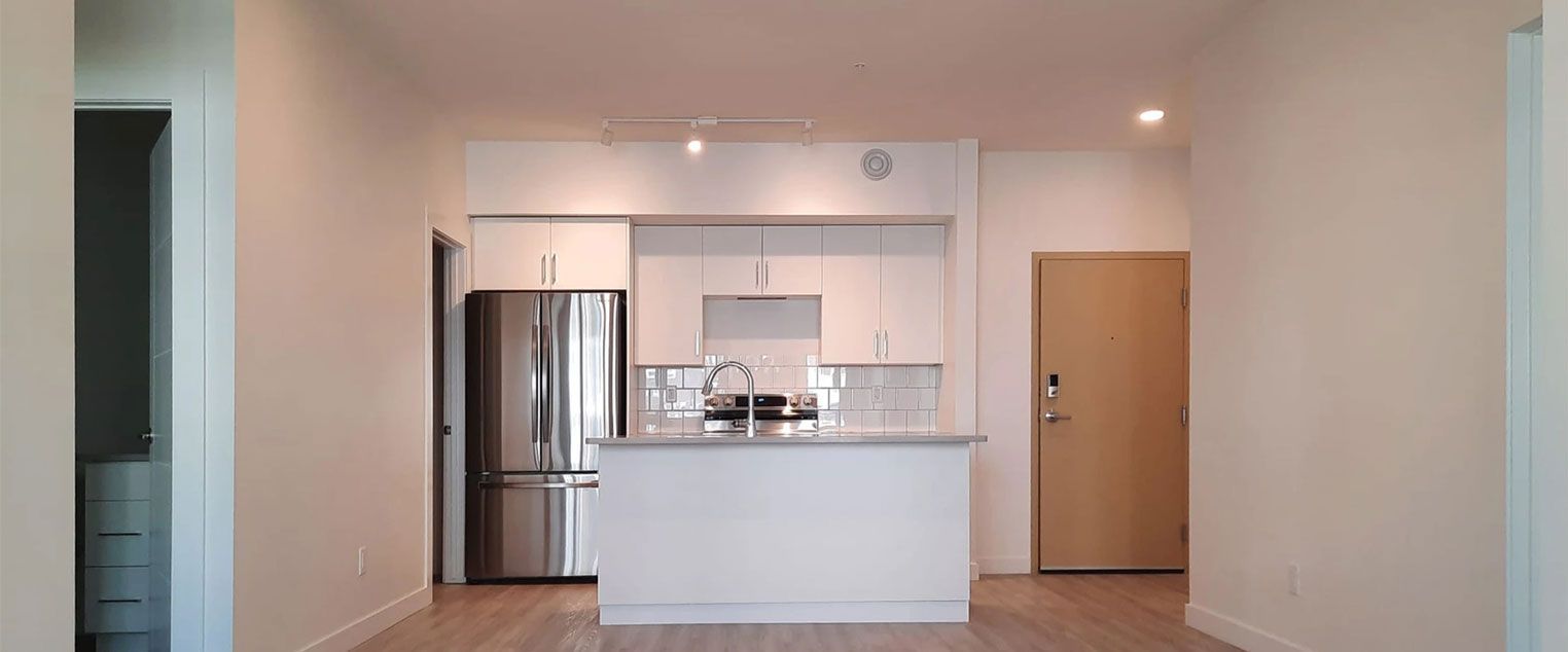 Well-lit apartment complex overlooking an open concept kitchen